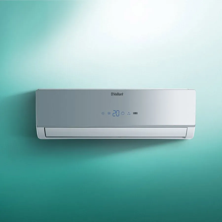 Wall-mounted air conditioner on a teal background